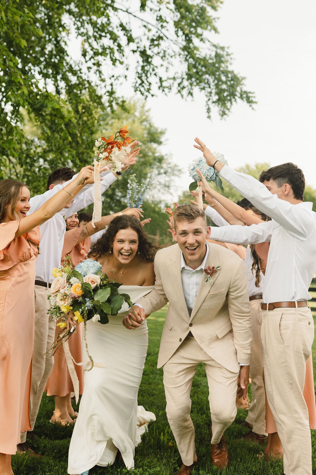 Tennessee wedding photographercaptures couple running through friends