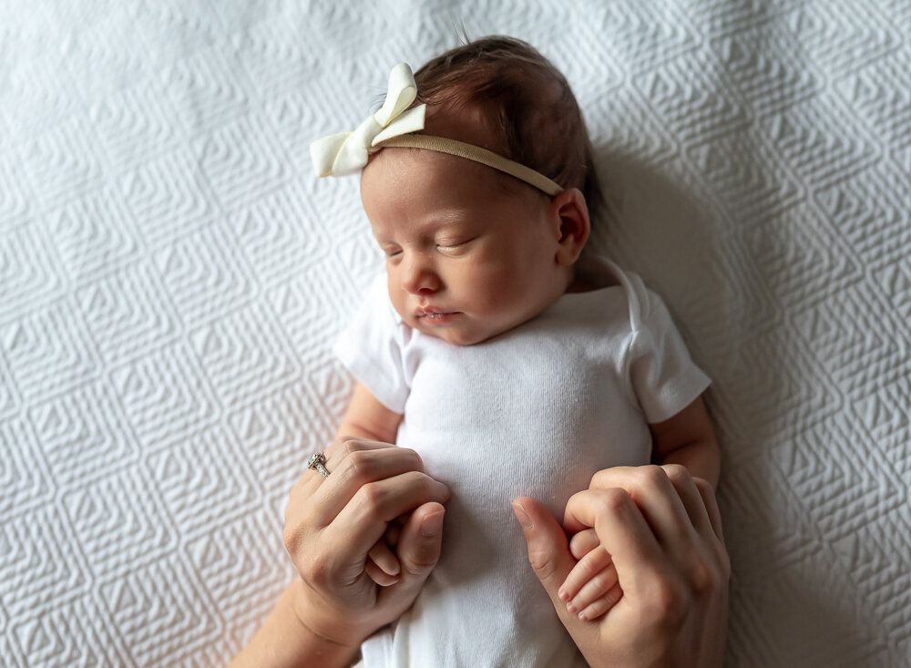 mom holding babies hands