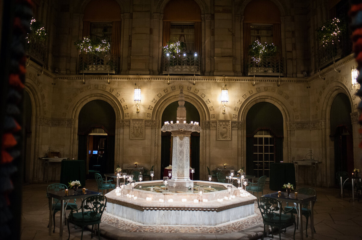 night photo of the duquesne club fountain courtyard