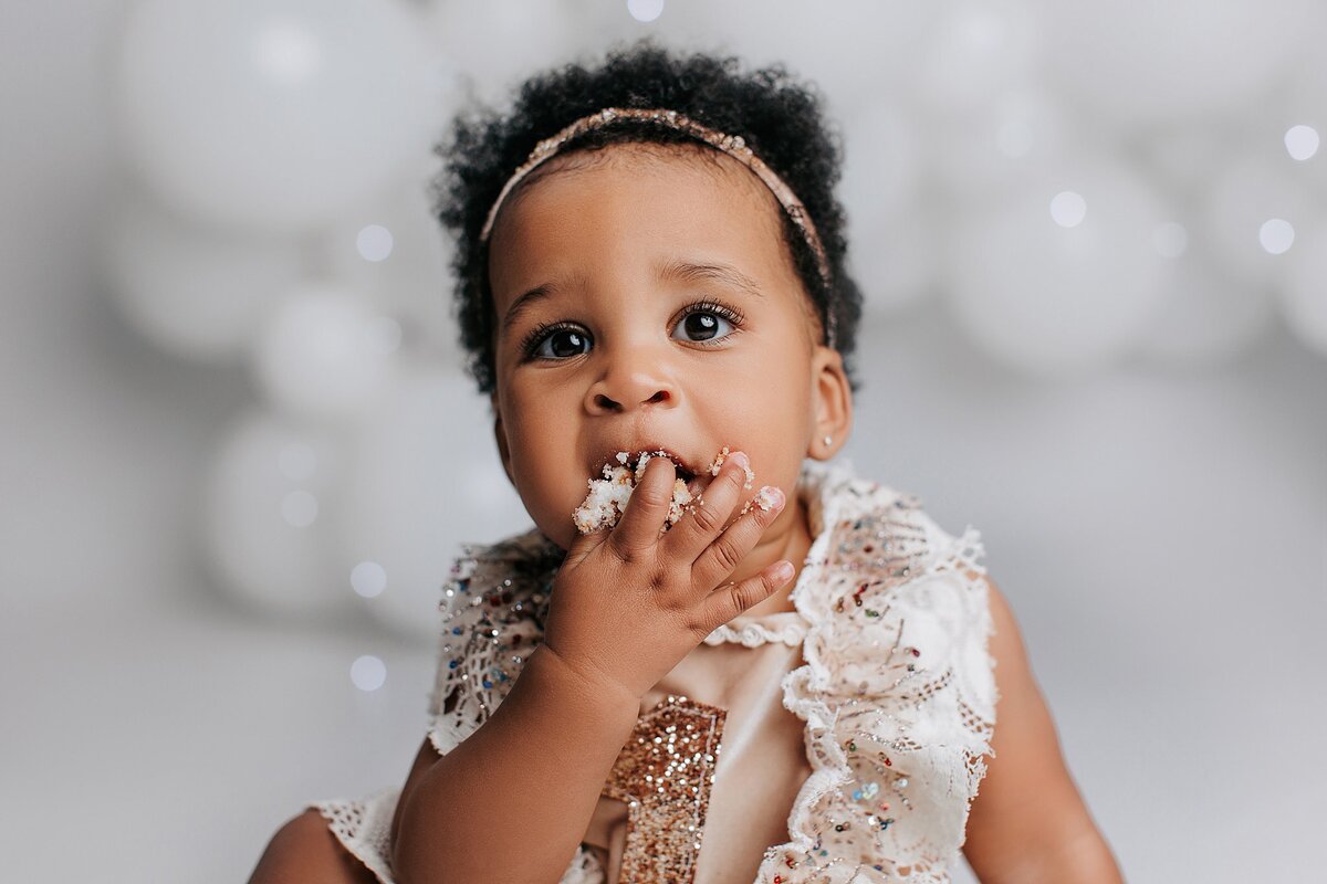 Minimalist cake smash setup with simple white cake and soft colors