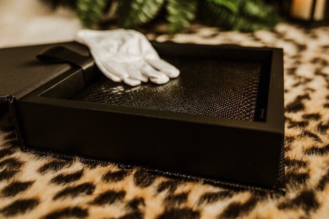 Boudoir photography keepsake album on leopard rug with white gloves in Lubbock, Texas photographer in Amarillo TX