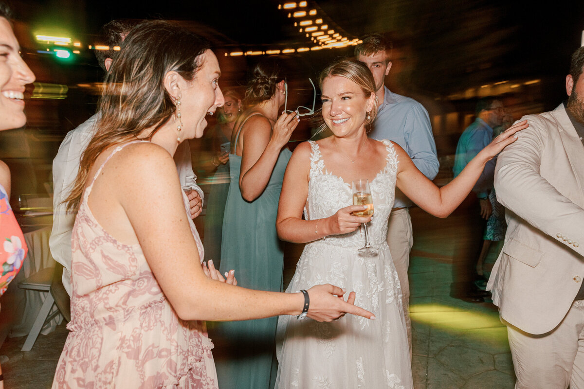 Bride laughs with guests during the evening celebration at her wedding in Cancun, Mexico.