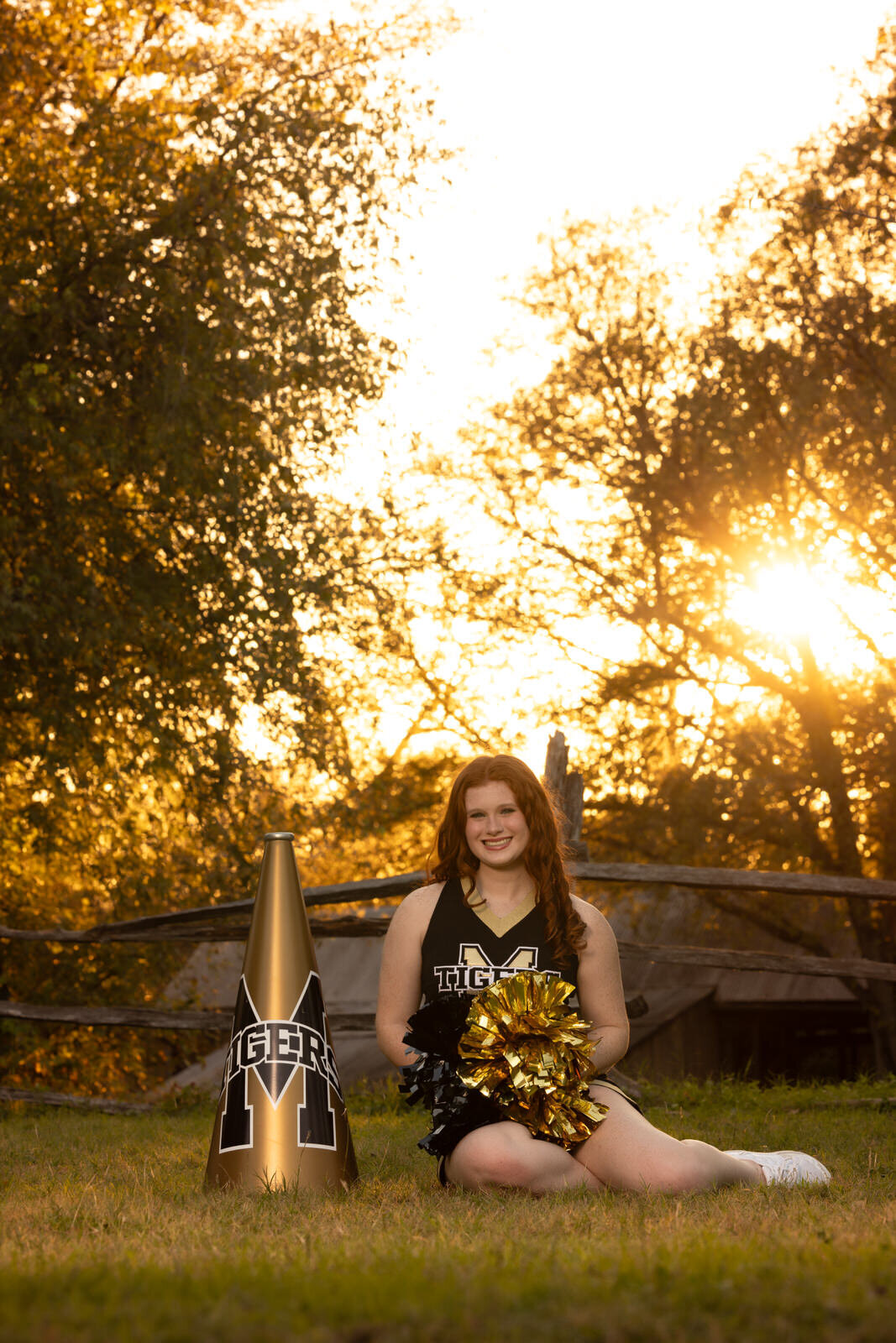 senior-girl=-sitting-with-cheer-gear