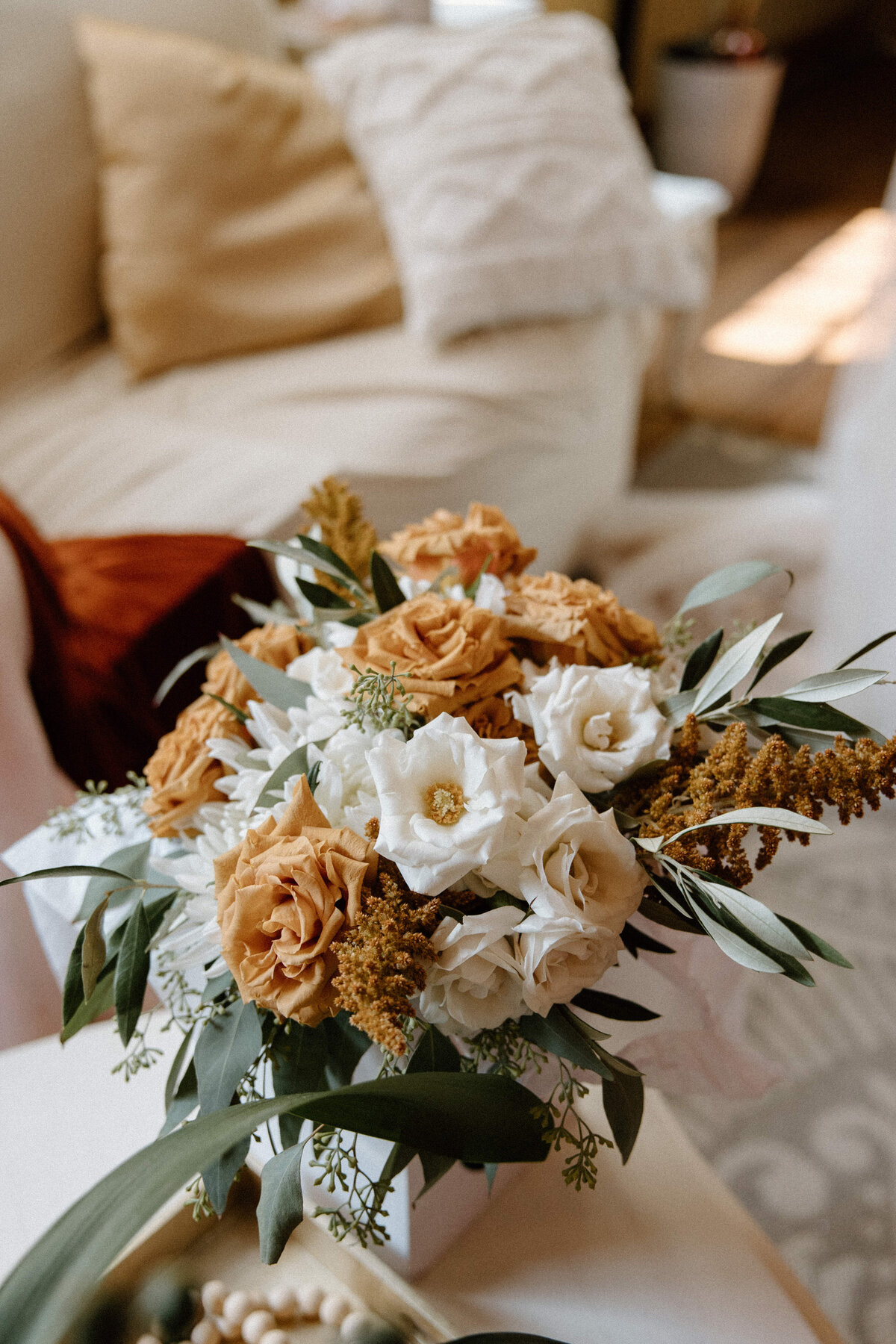 A close-up view of the bride's autumn themed flower bouquet lying in the table