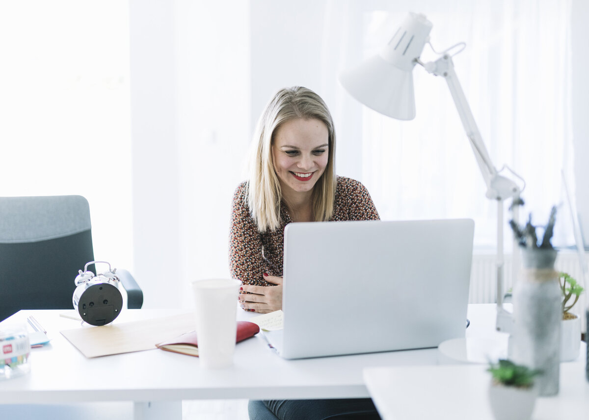 A happy businesswoman working on a call with a client.