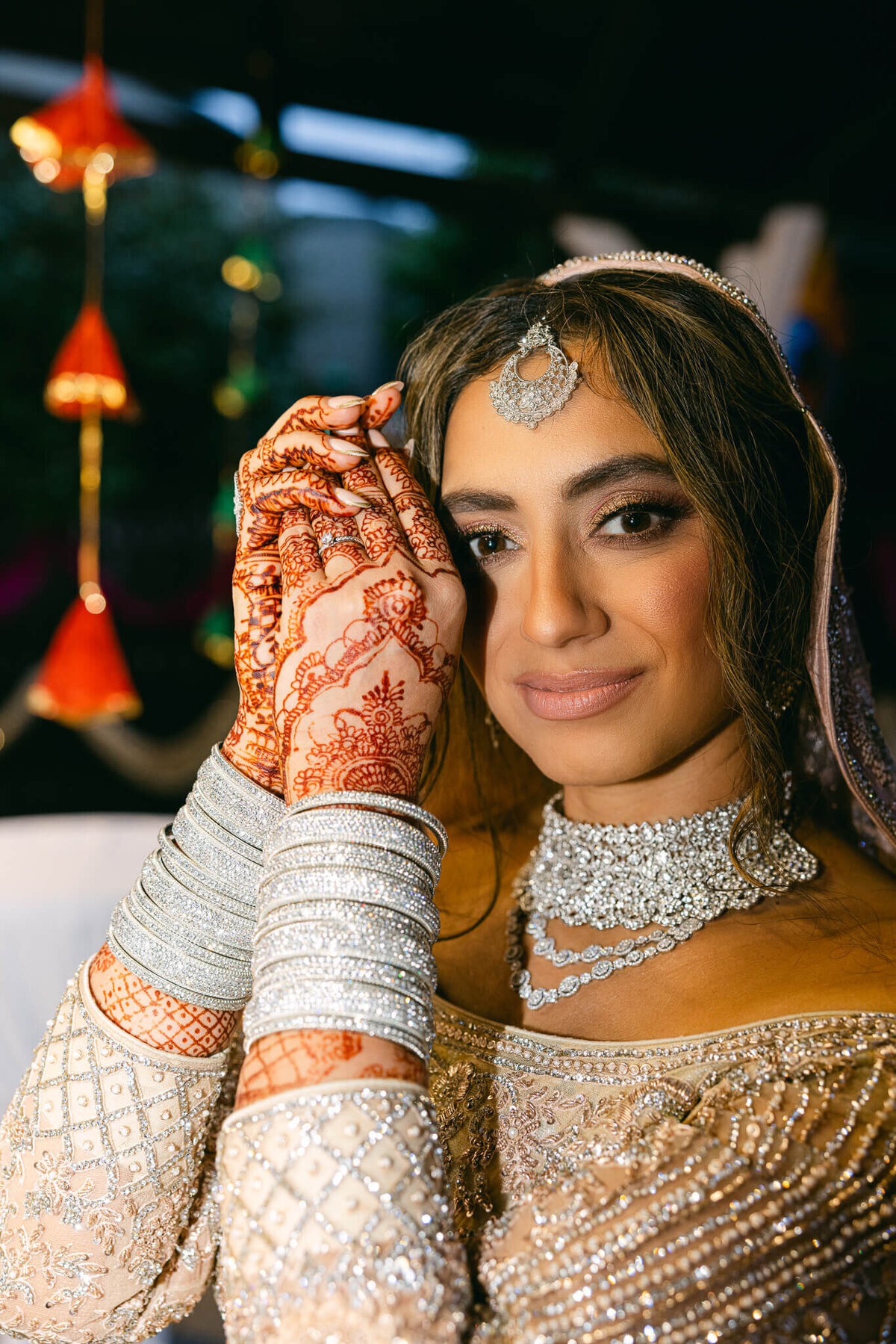 A wedding photo of the bride smiling at the camera showing off her  wrist jewelry in Dublin Ireland