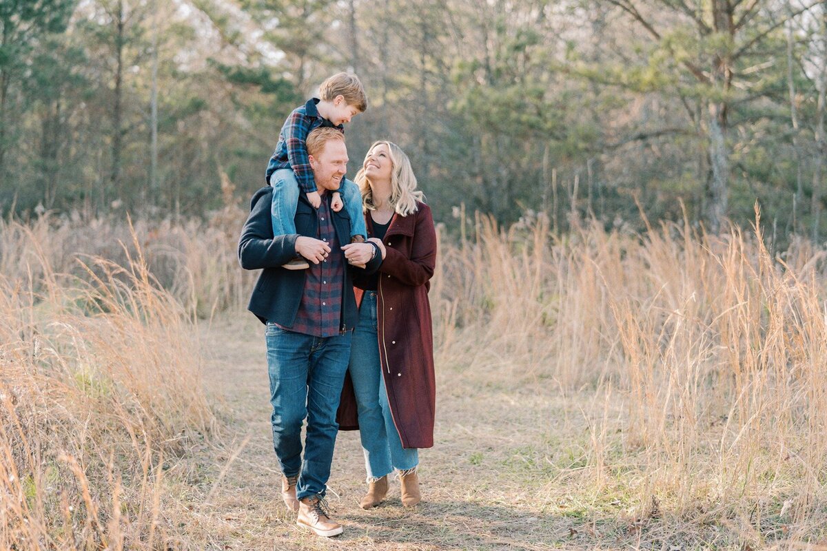 family-of-three-walking-and-smiling