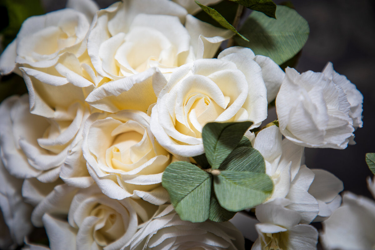 Lasting wedding bouquet of creamy white roses and lisianthus