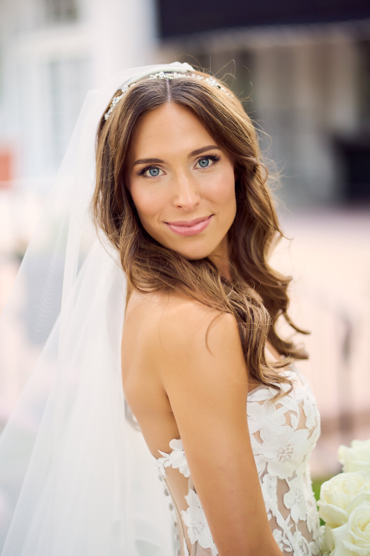 Bride with soft curls and bridal glam makeup in Rockford, IL. Wedding hair and makeup services