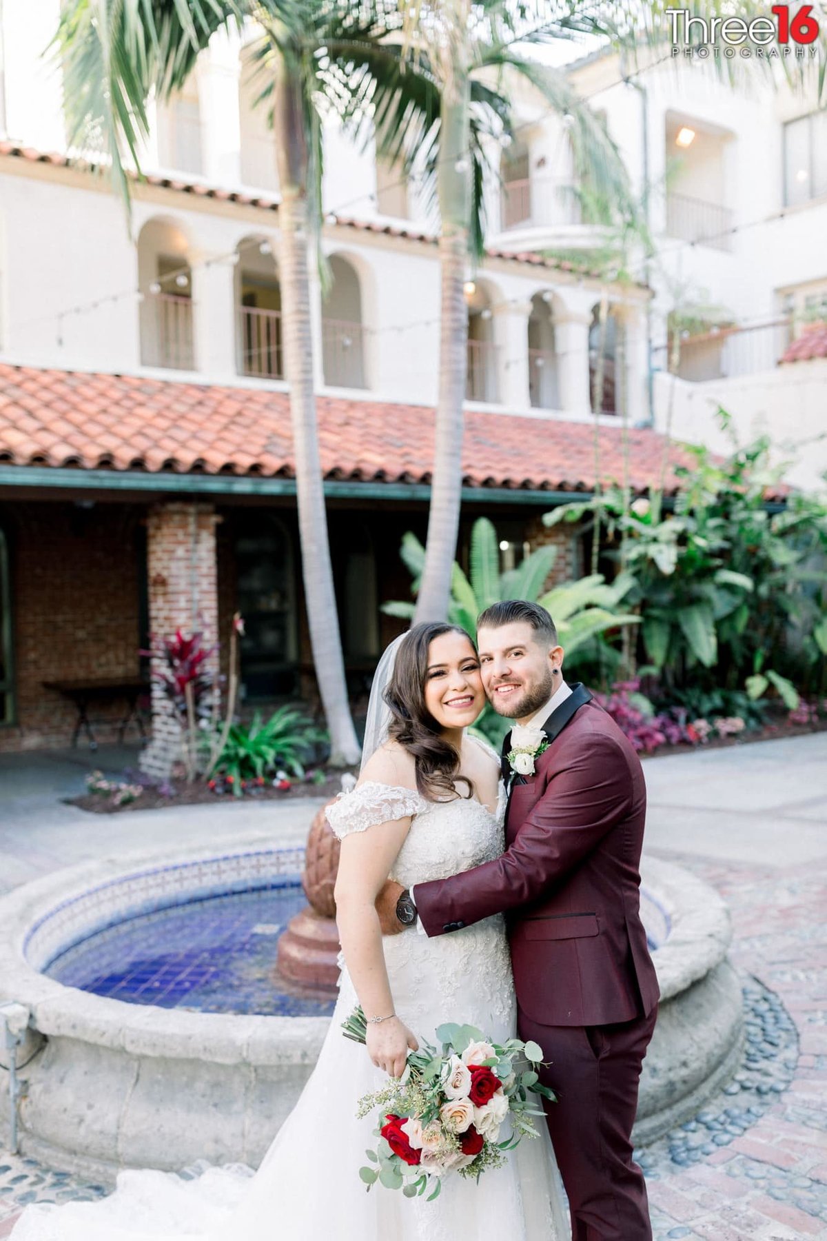 Bride and Groom pose for photos in front of the water fountain at Casa Bonita