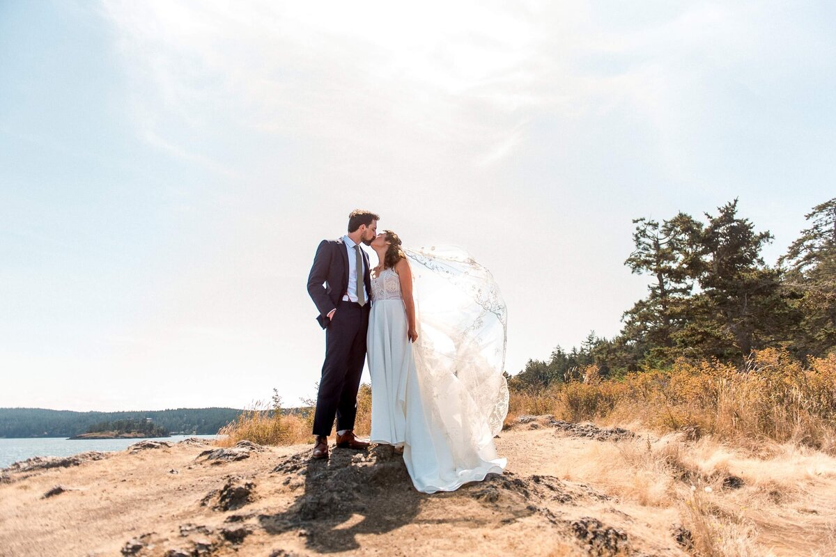 Bride and groom on the rocky shore at a Vashon Island wedding