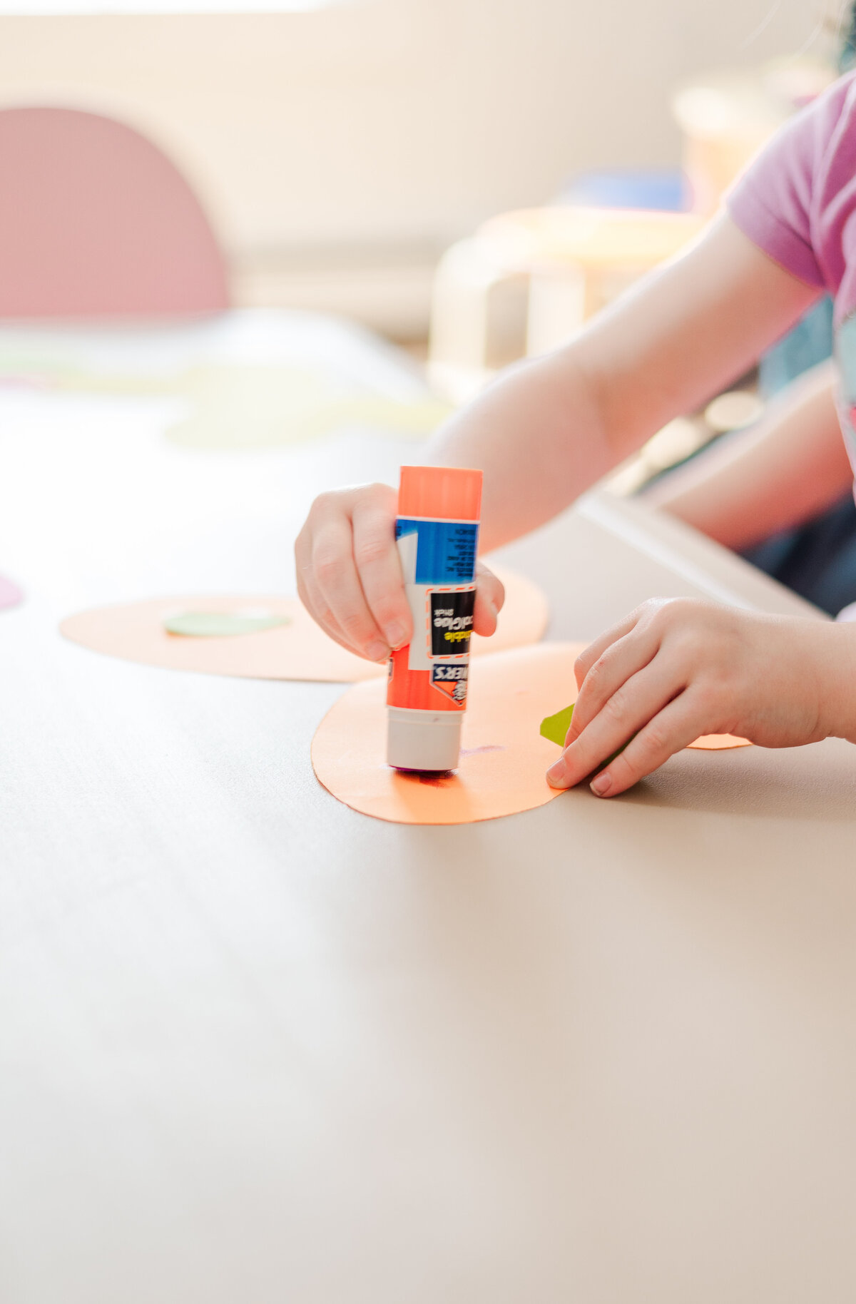 Student gluing craft at House of Parker Preschool Gorham Maine
