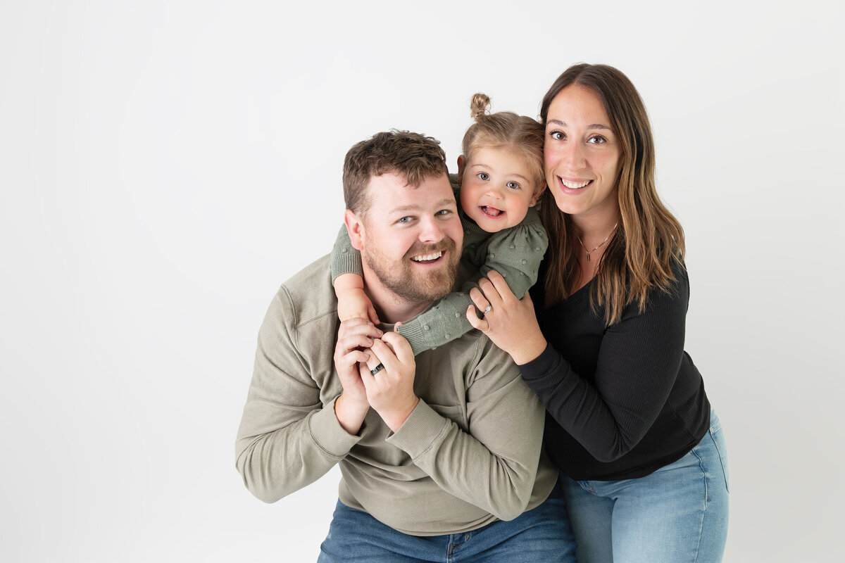 Playful studio in Paris, Ontario family photo with daughter hugging her dad | Paris Ontario photographer