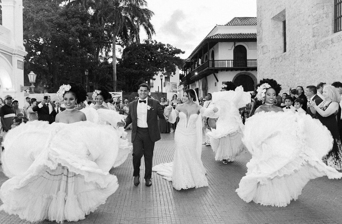 A joyful wedding moment as Victoria and Daniel celebrate with a Colombian dance performance.