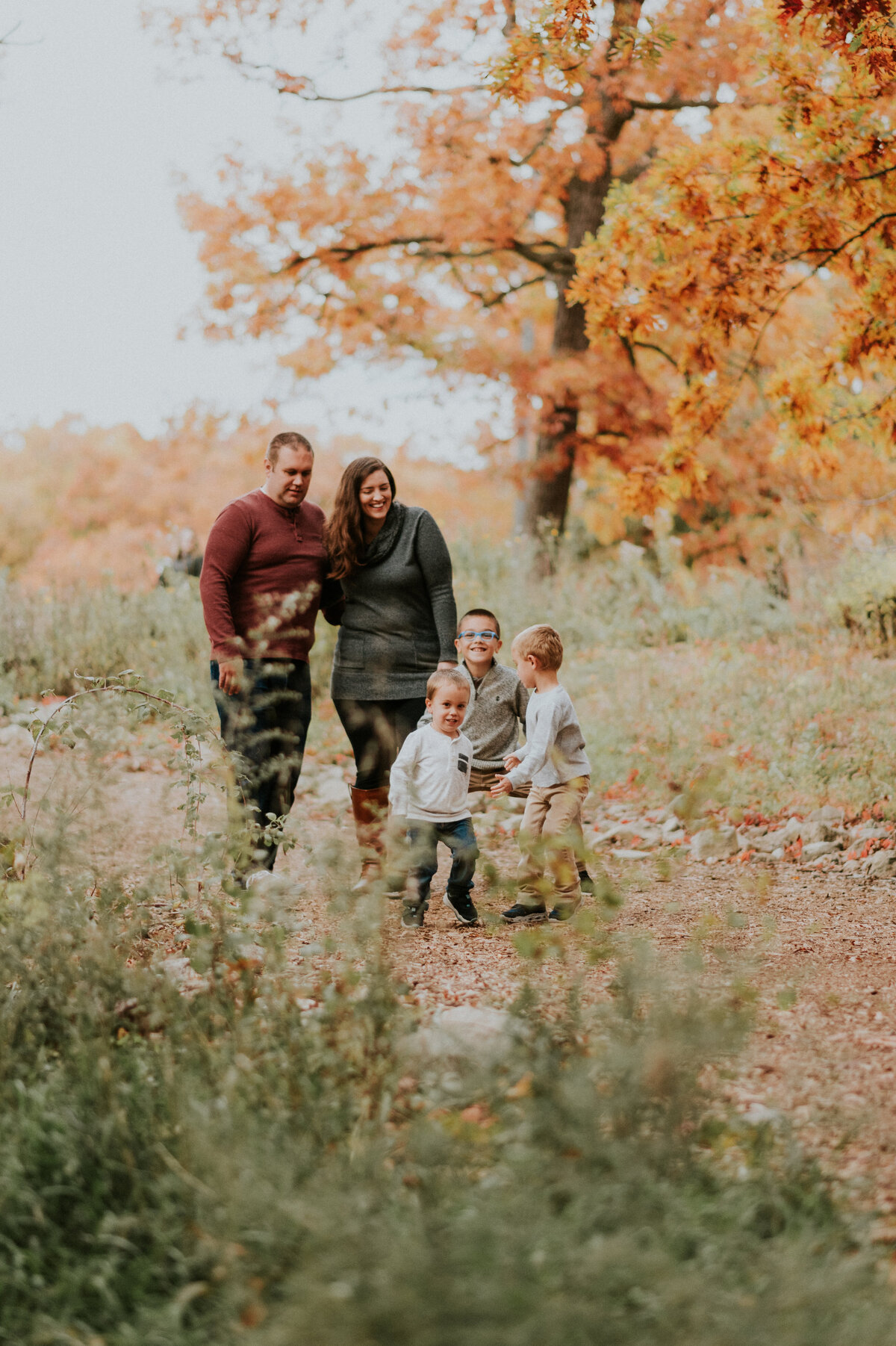 Experience the joy of family togetherness with this candid portrait captured at Silverwood Park in New Brighton, MN. Join the journey as a family of five shares a delightful stroll down a scenic path, creating timeless memories in a beautiful natural setting