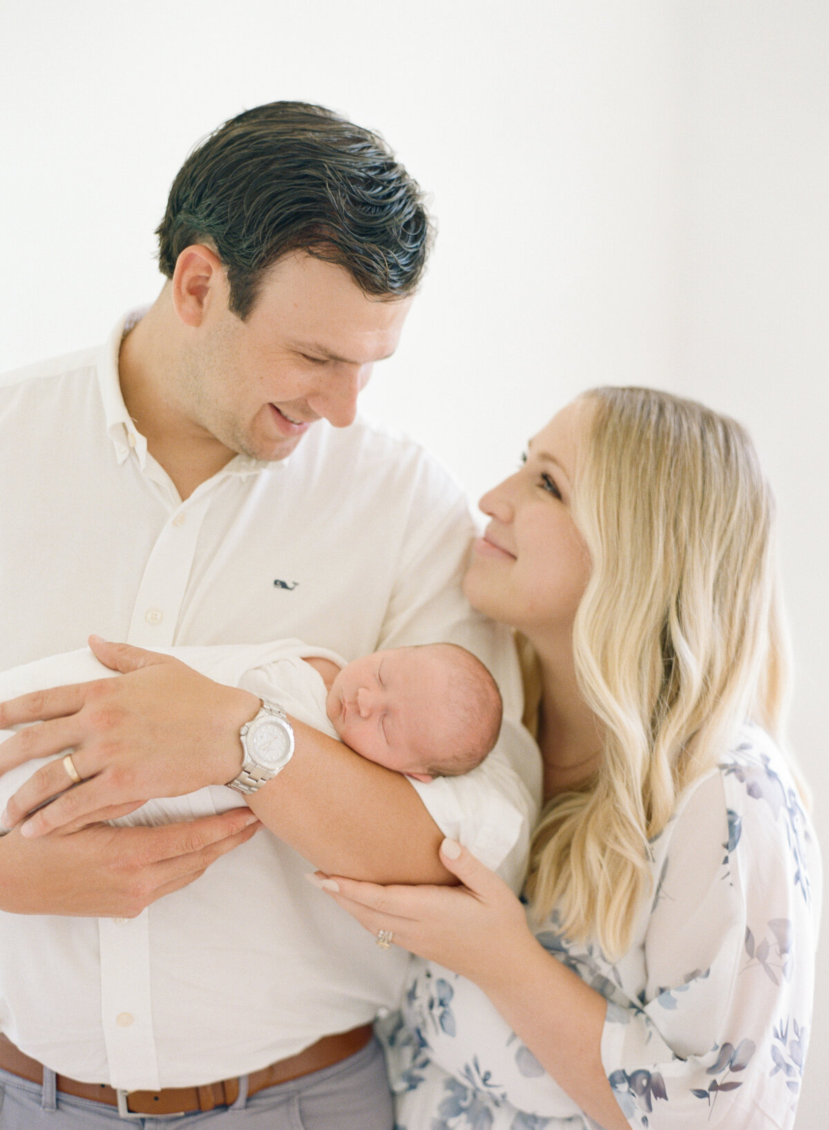 New parents during an in home newborn session in raleigh. Image by Raleigh newborn photographer A.J. Dunlap Photography.