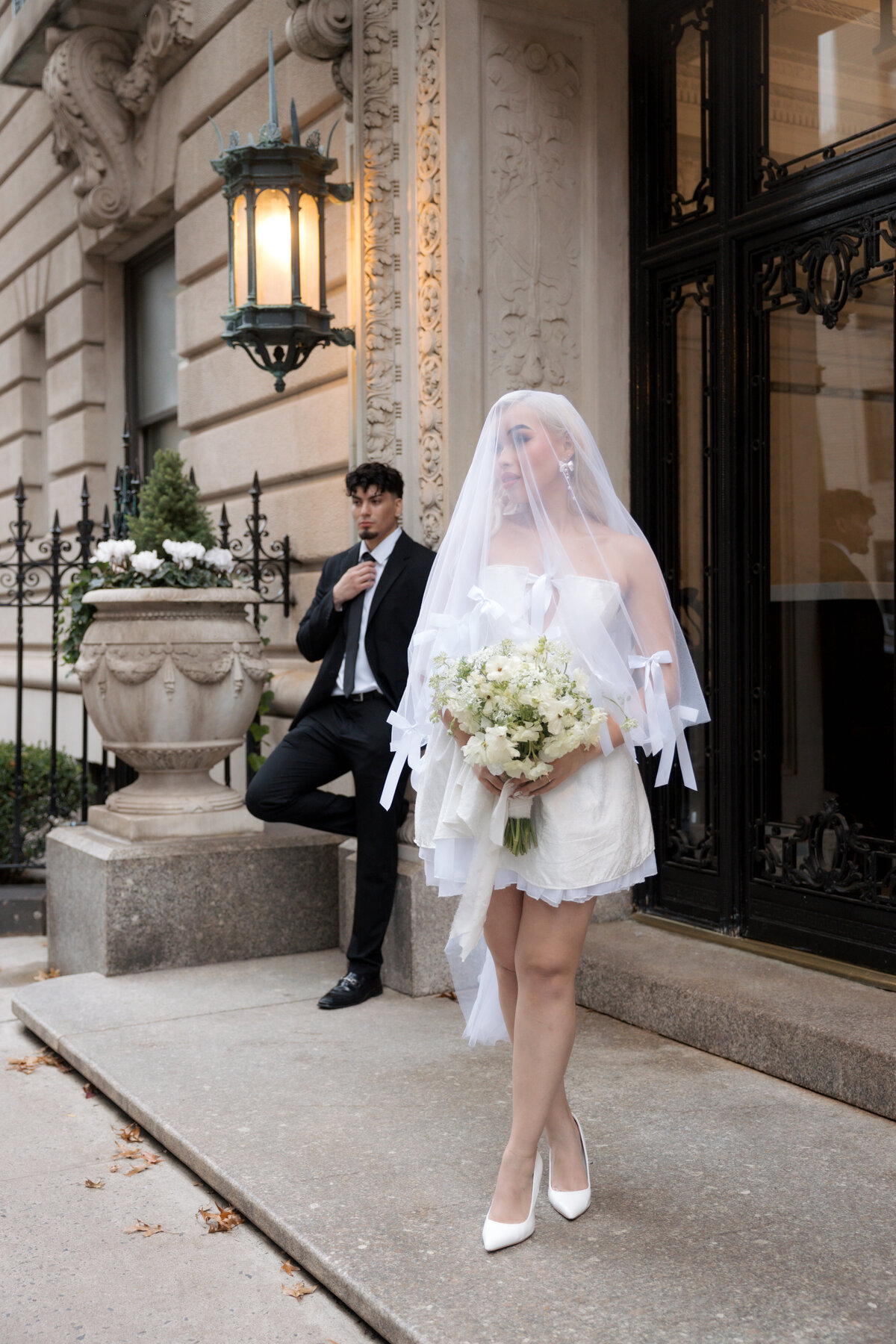 Close-up shot of the bride’s bouquet with NYC streets softly blurred in the background.