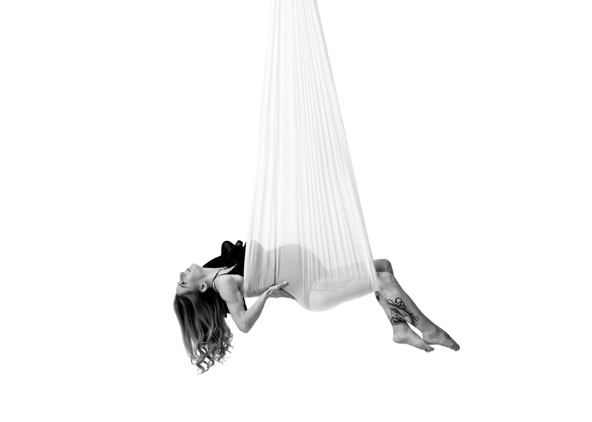 Maternity photography  image of pregnant mum-to-be looking radiant and on a white background.  A light and vibrant image by Lauren Vanier expert Hobart Maternity Photographer