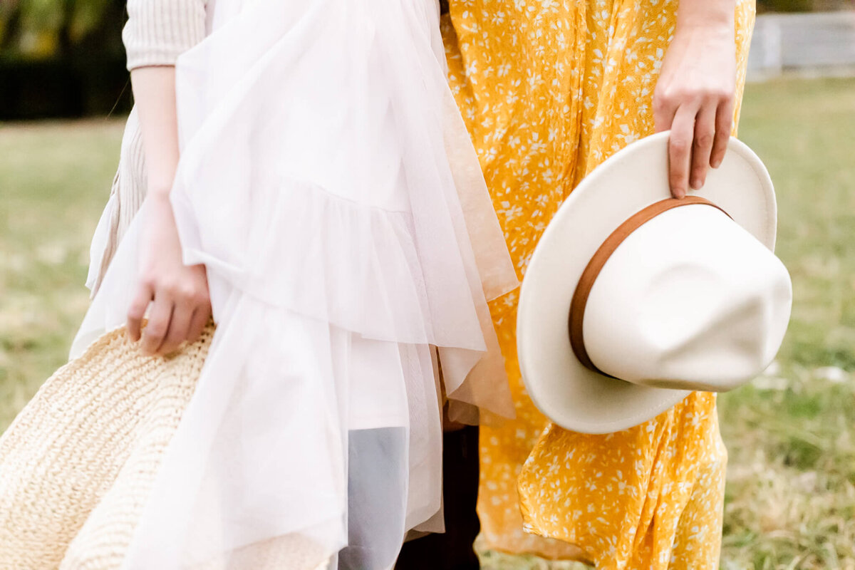 Mom and daughter carrying hats on Sunset Farm near Naperville. IL.