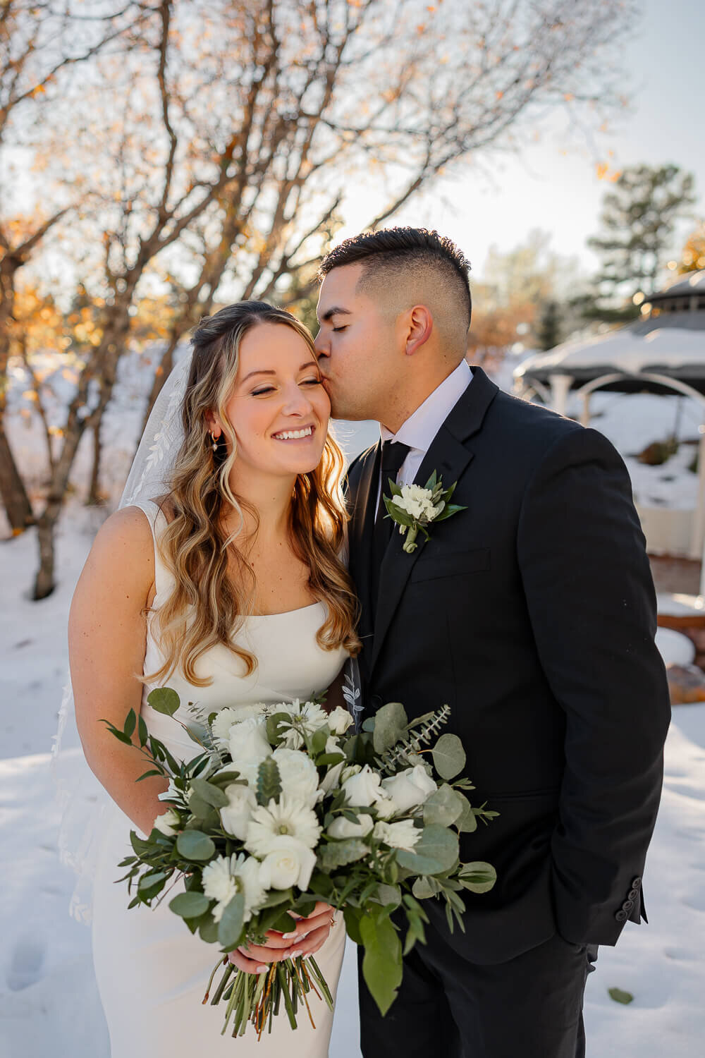 Close-up of a bride holding a vibrant bouquet of flowers with mountain views in Colorado Springs, photographed by Michelle Betz Photography, specializing in Colorado Springs weddings."