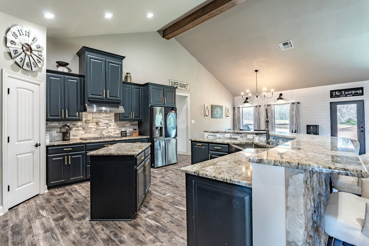 Fully stocked kitchen with bar top seating in this five-bedroom, 3-bathroom vacation rental house for up to 10 guests with free wifi, private parking, outdoor games and seating, and bbq grill on 2 acres of land near Waco, TX.