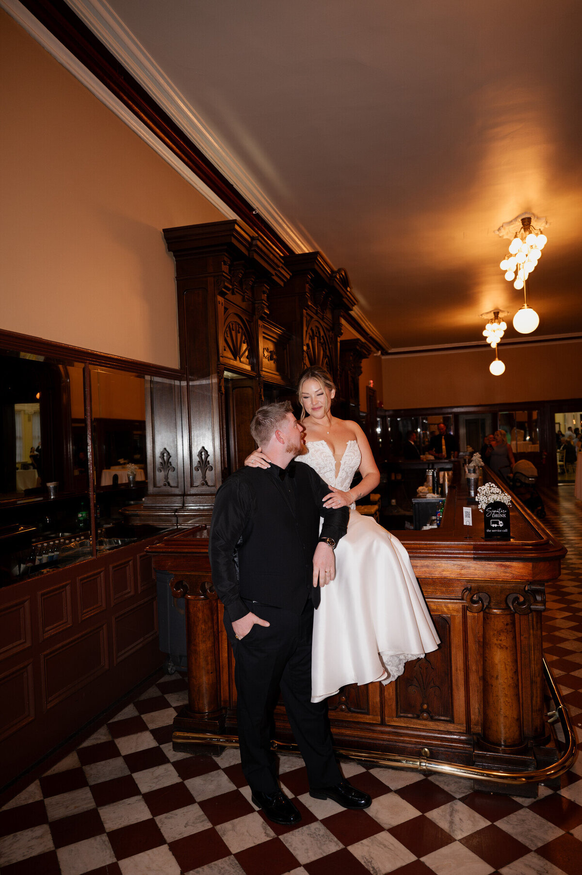 Portraits of the bride and groom at the bar inside the Canfield Casino in Saratoga Springs, NY during their Belmont weekend wedding.