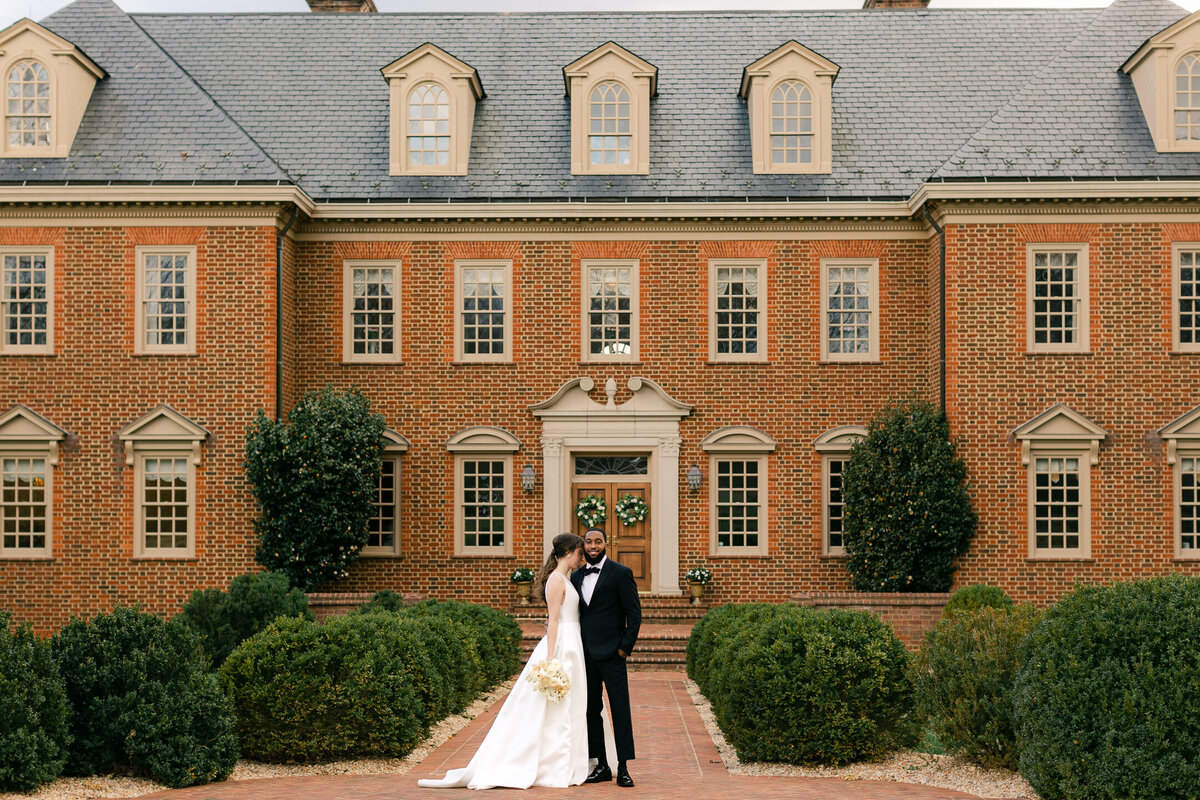Wedding Photographer, a bride and groom stand before a large estate