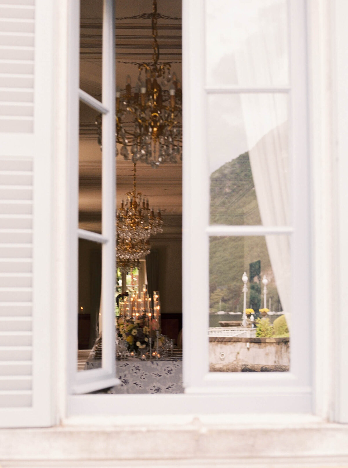 A wedding day photo of the reception cable covered in linens and candles at the wedding venue Villa Aura del Lago on Lake Como in Italy