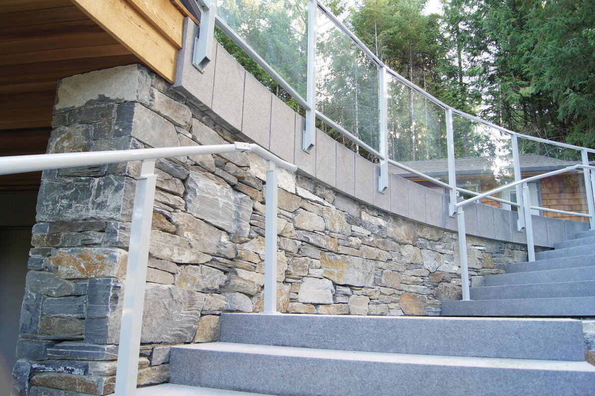 Exterior stairwell design with  concrete steps & stone inlay.