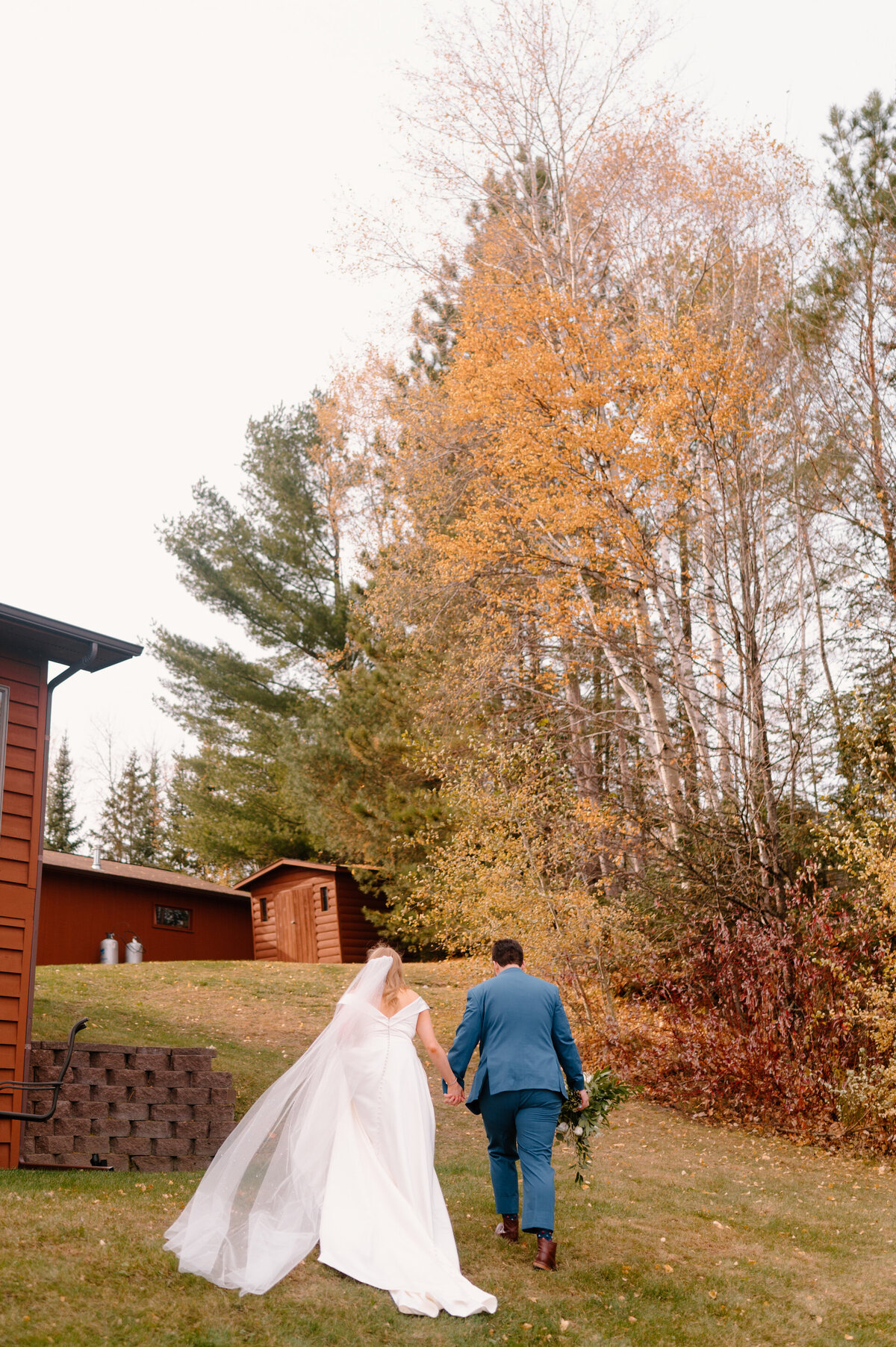 bride and groom walking at backyard wedding