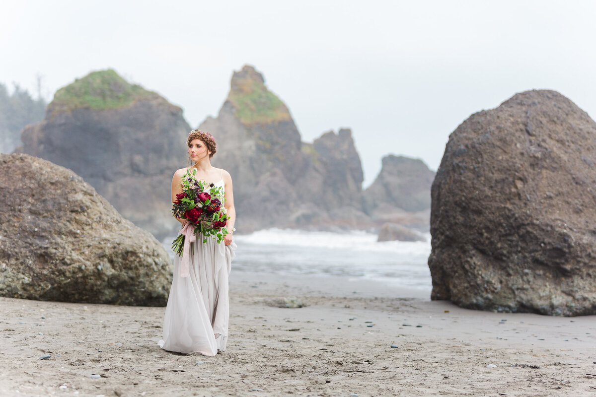 Bride-at-elopement-with-large-wild-flower-bouquet-at-Ruby-Beach-Olympic-Peninsular-WA-Joanna-Monger-Photography