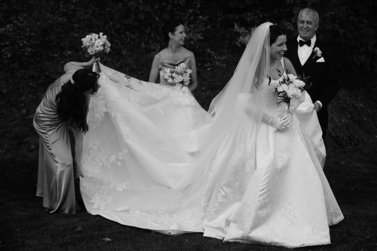 Vermont Wedding Photographers | Sincerely Liz Photography Documentary Wedding, Engagement, Elopement, Maternity and Newborn Photographer in New England | Bridesmaids hold smiling bride's gown and veil