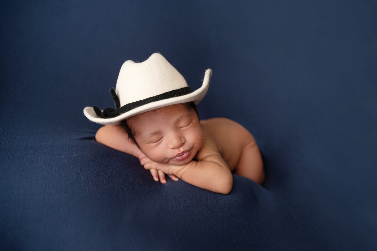 fort worth newborn boy wearing cowboy hat