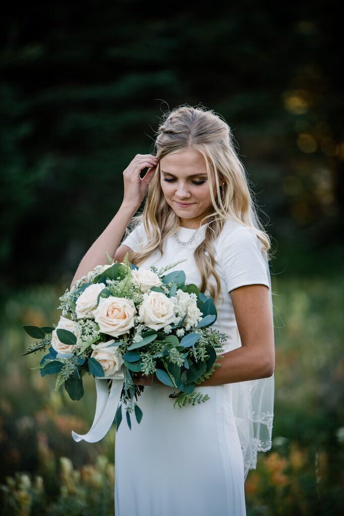 bride-holding-cream-bridal-bouquet-outdoors - jpeg