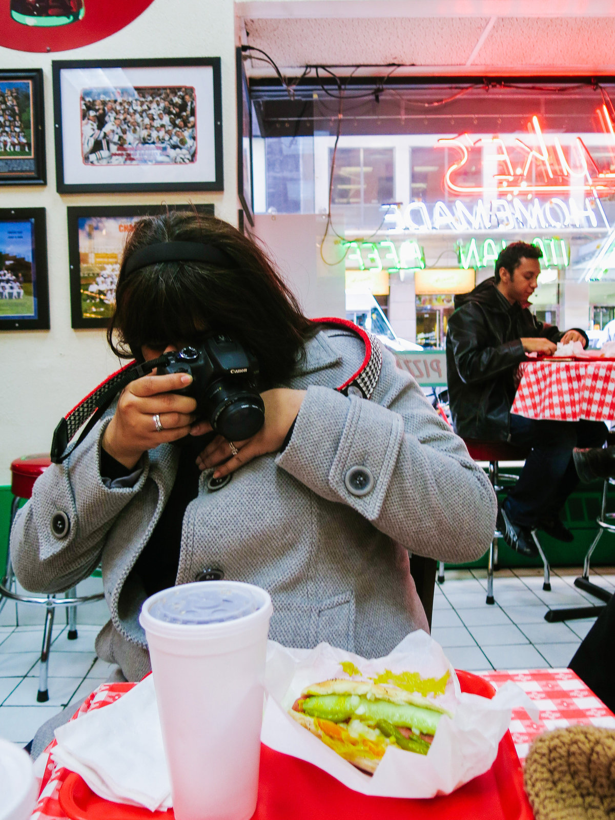 Irene Castillo taking pictures of a real Chicago hot dog