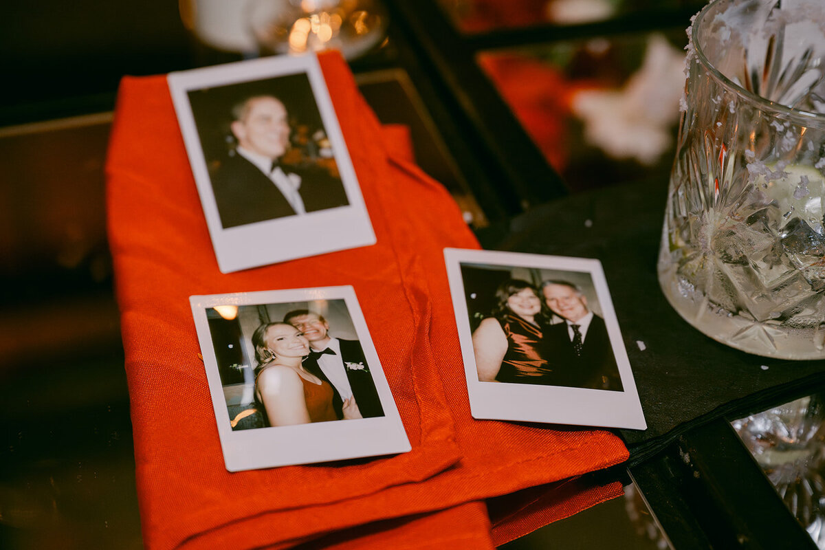 Reception detail featuring red guestbook table and instant prints at luxury Texas wedding