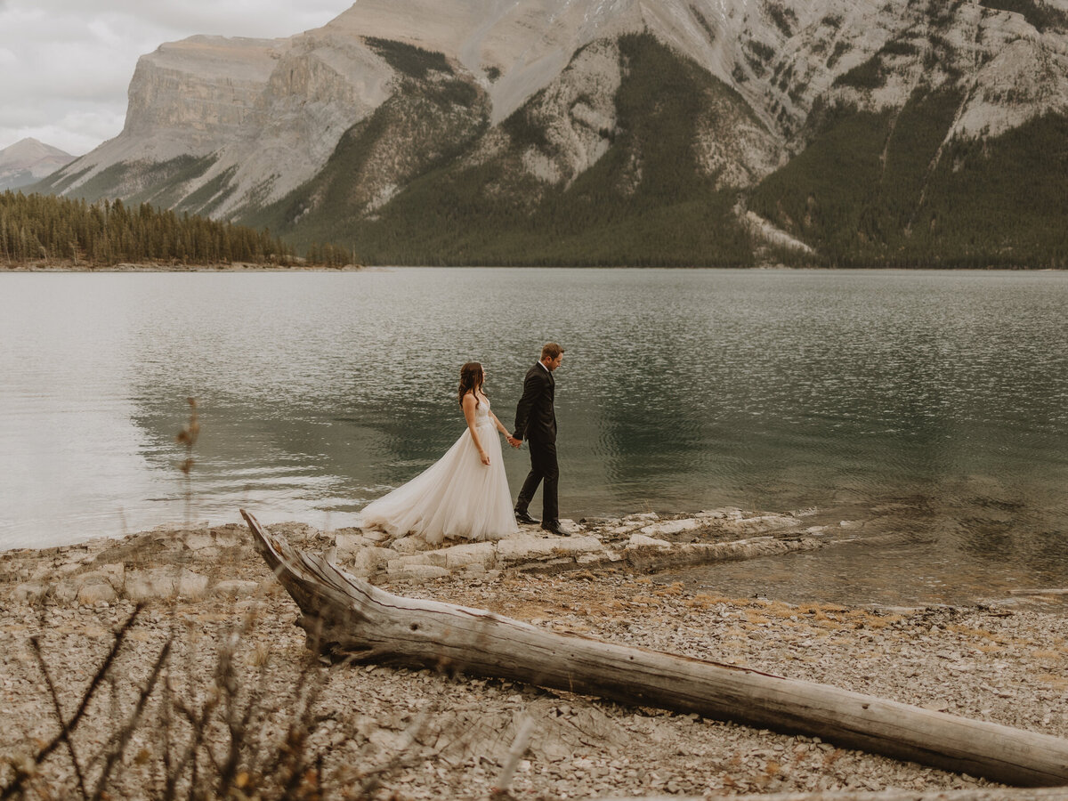 Bride and Groom walking around at lake minnewanka , Banff Alberta