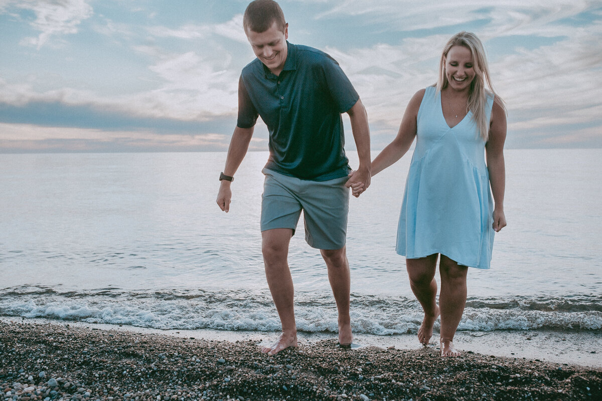 husband and wife walking on beach