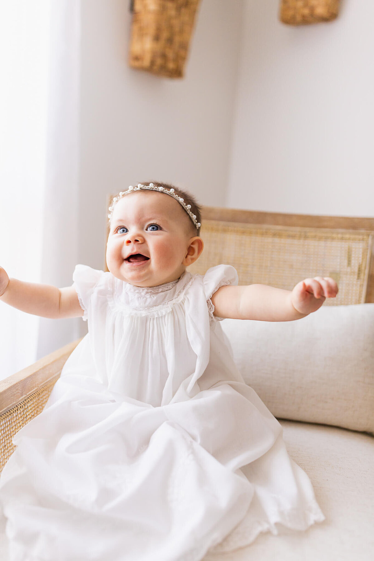 A happy baby girl celebrates while sitting in a chair