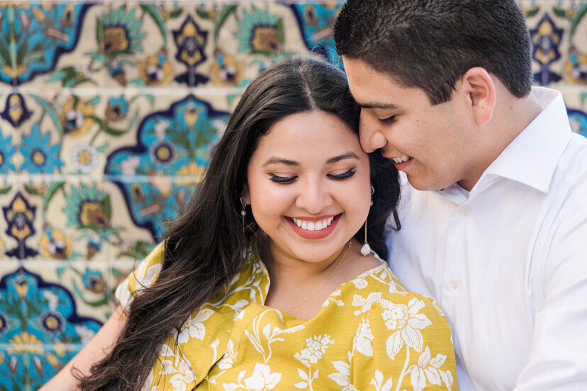 engaged couple sitting by tile mosaic