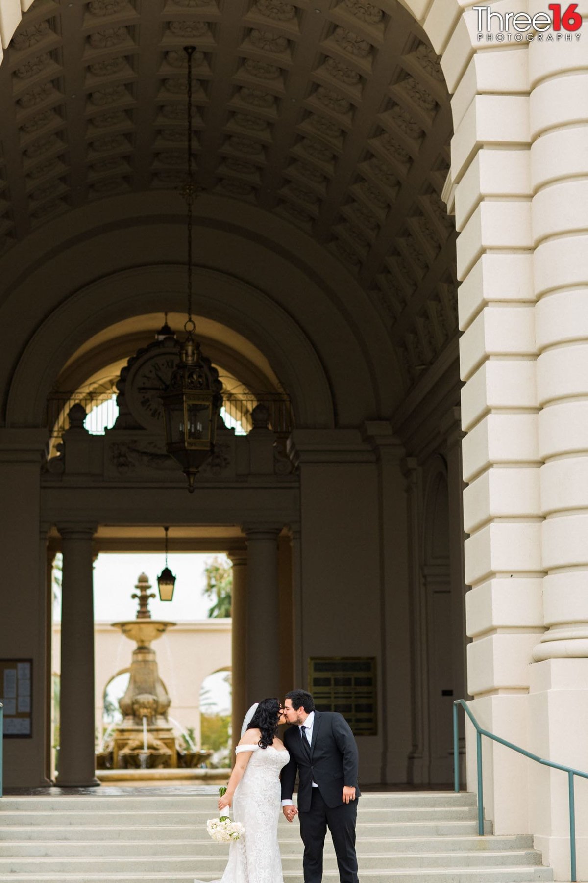 Bride and Groom share a kiss on the steps of the Pasadena City Hall