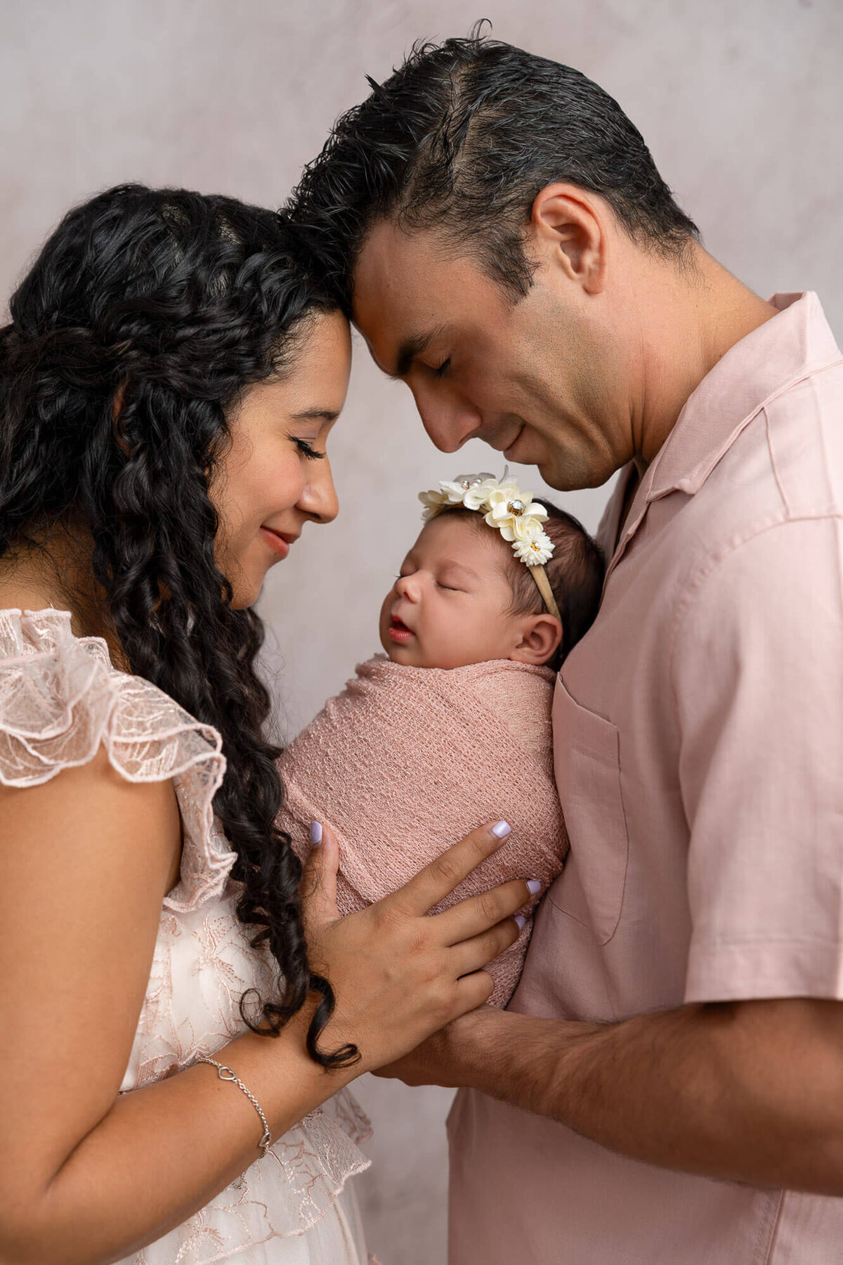 mom and dad holding newborn captured by lv photo haus llc 