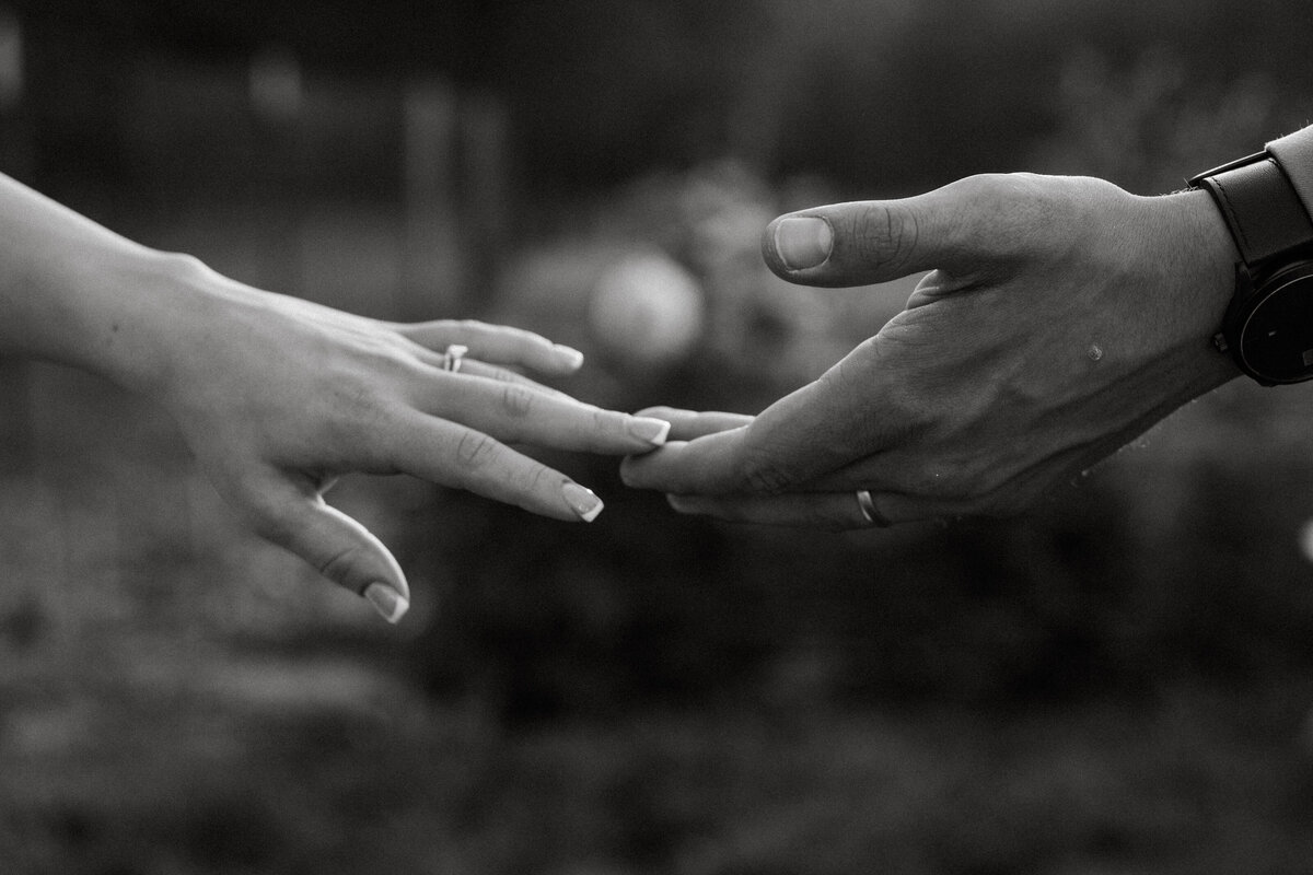 bride and groom touching hands in idaho