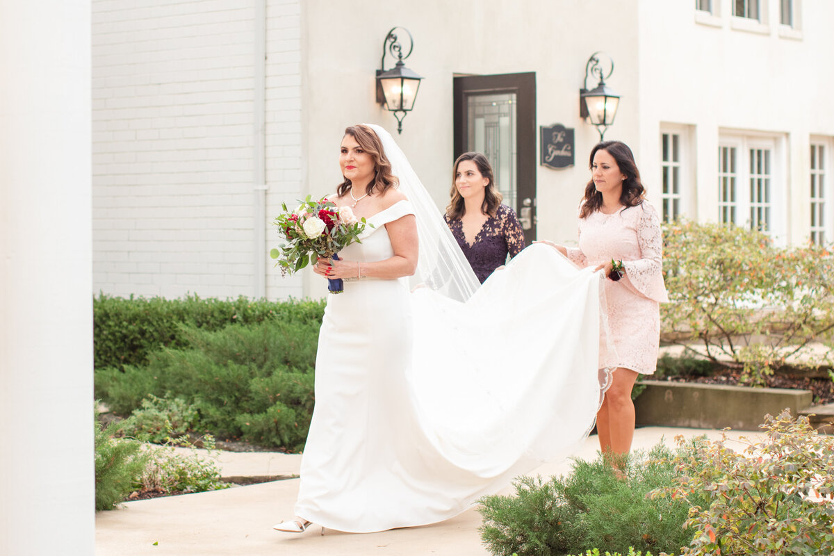 walking down aisle at Gardens of West Green by San Antonio wedding photographer Firefly Photography