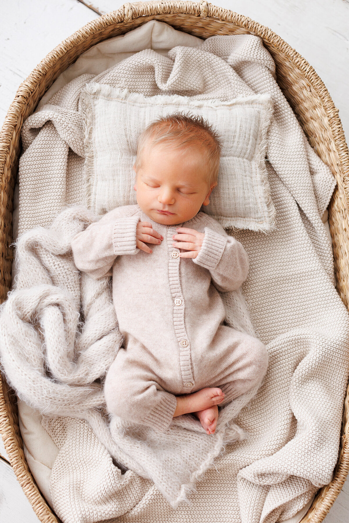 naturalposednewbornwithblondhairinbasket