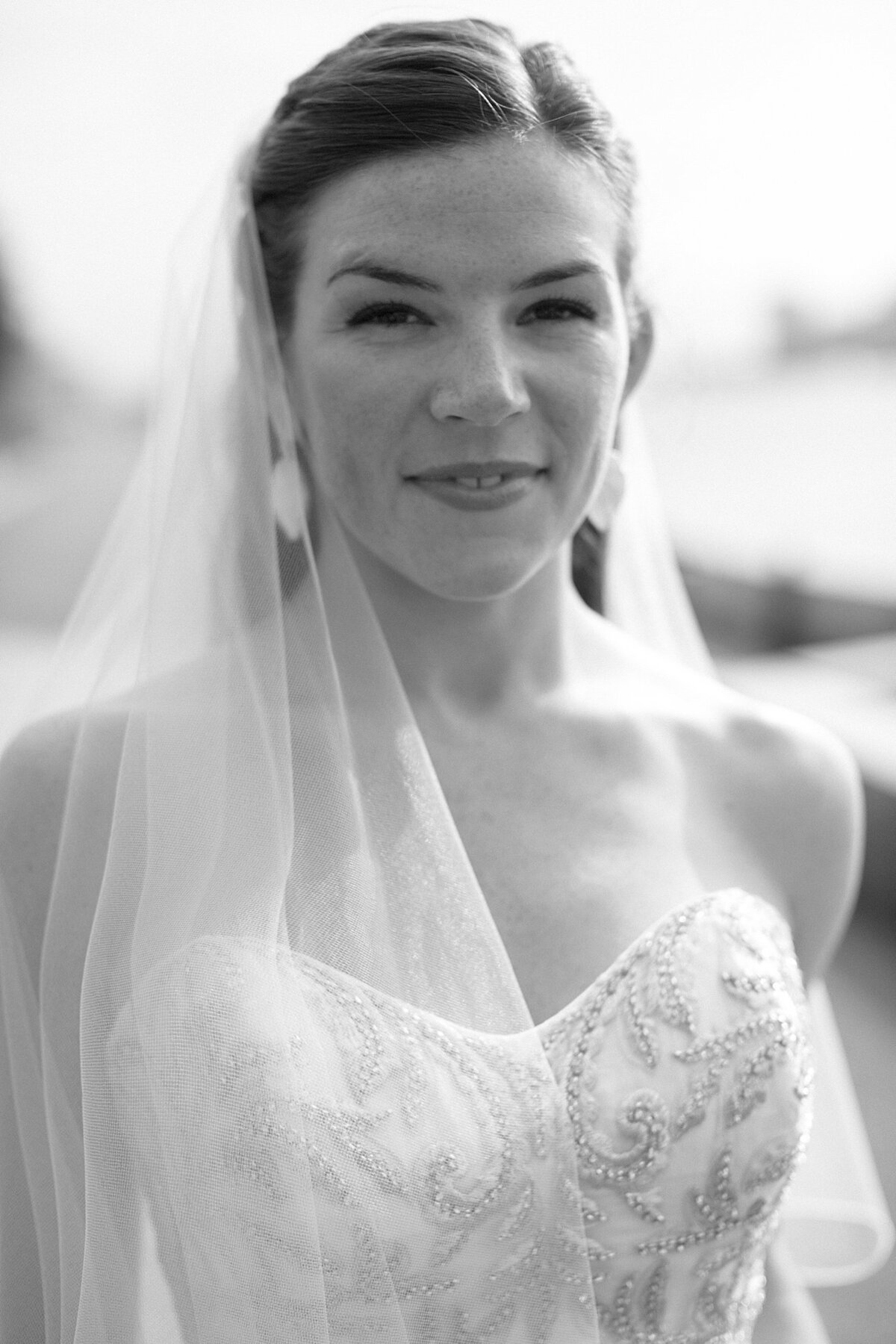 Bride poses and faces camera during Boston wedding.