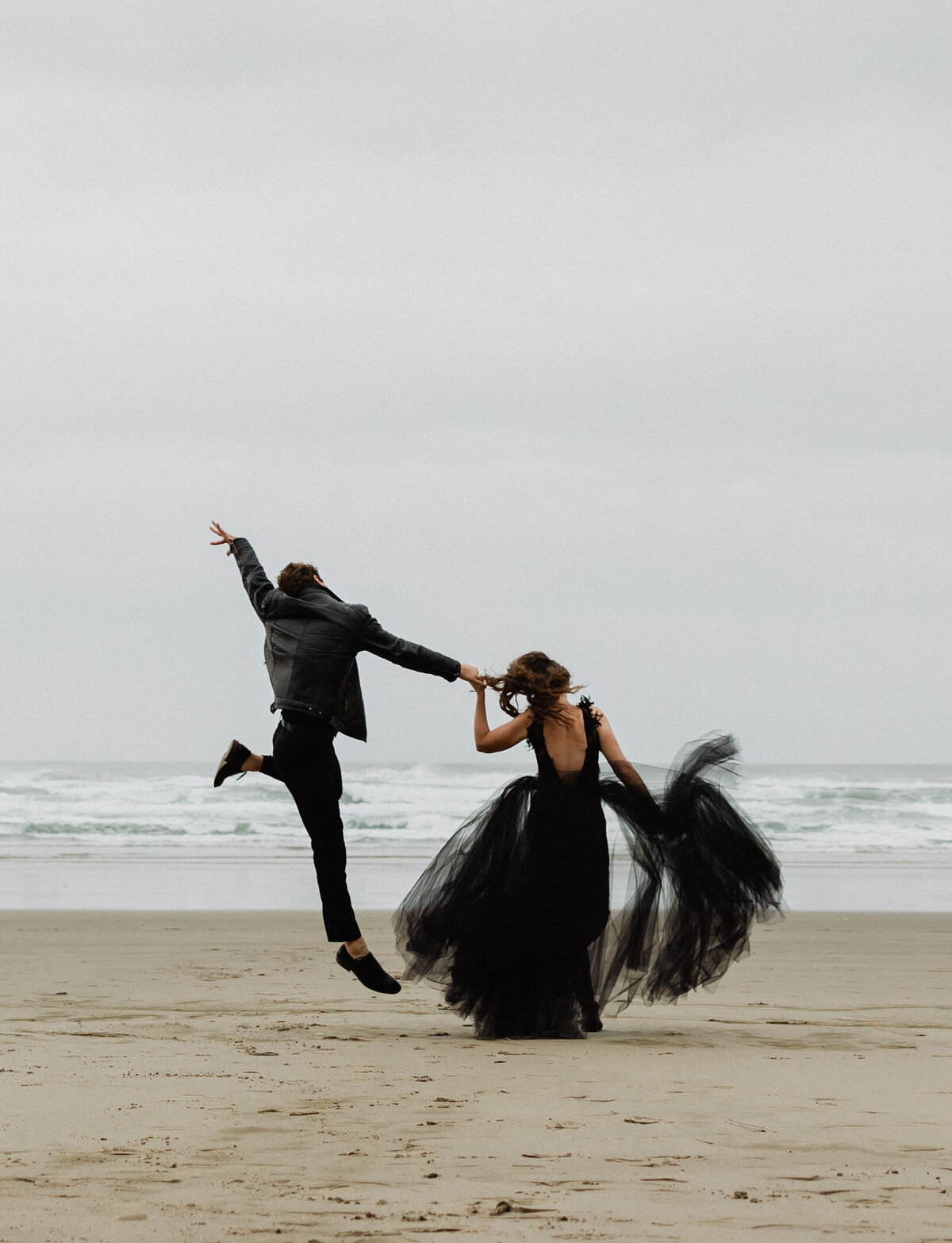 oregon elopement, pnw wedding, black wedding attire, black wedding dress, groom jumping holding hands with bride