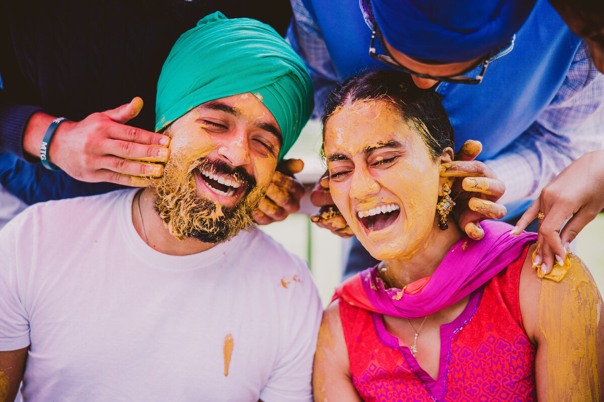 Sikh couple at their joint indian maiyaan ceremony getting haldi put on together
