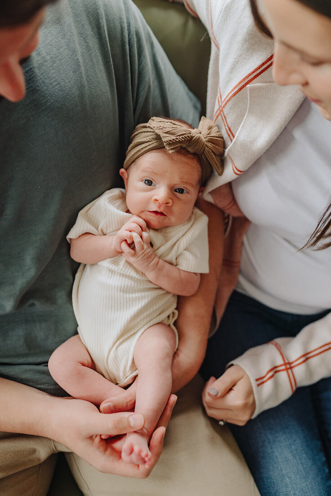 newborn baby with couple looking down at  newborn photo session at Finger Lakes, NY