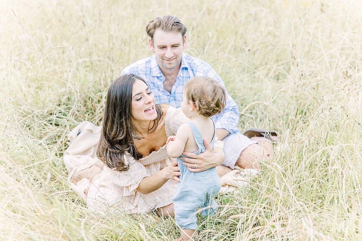 family in tall grass duirng summer  family photo session with Sara Sniderman Photography in Natick Massachusetts